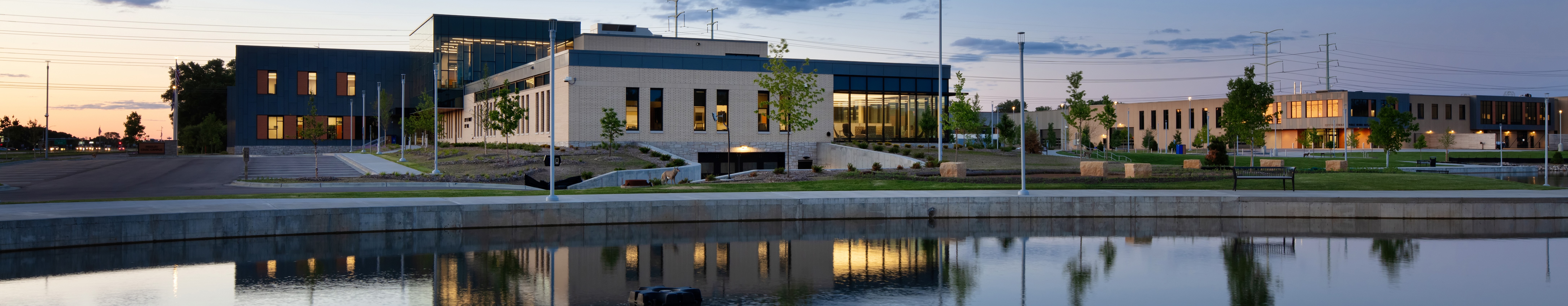 Image of the Civic campus and the pond at dusk