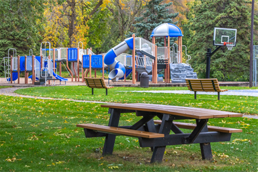A park bench and a playground