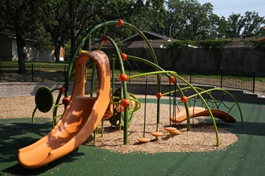 A small playground set with a slide and a climbing feature