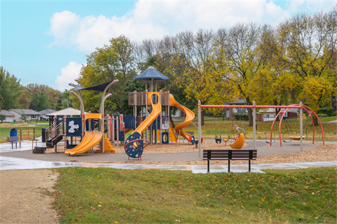 A playground set with slides, swings and ladders