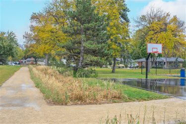 A gravel trail next to a basketball court
