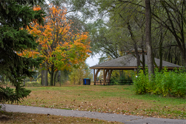 A park shelter next to a paved trail