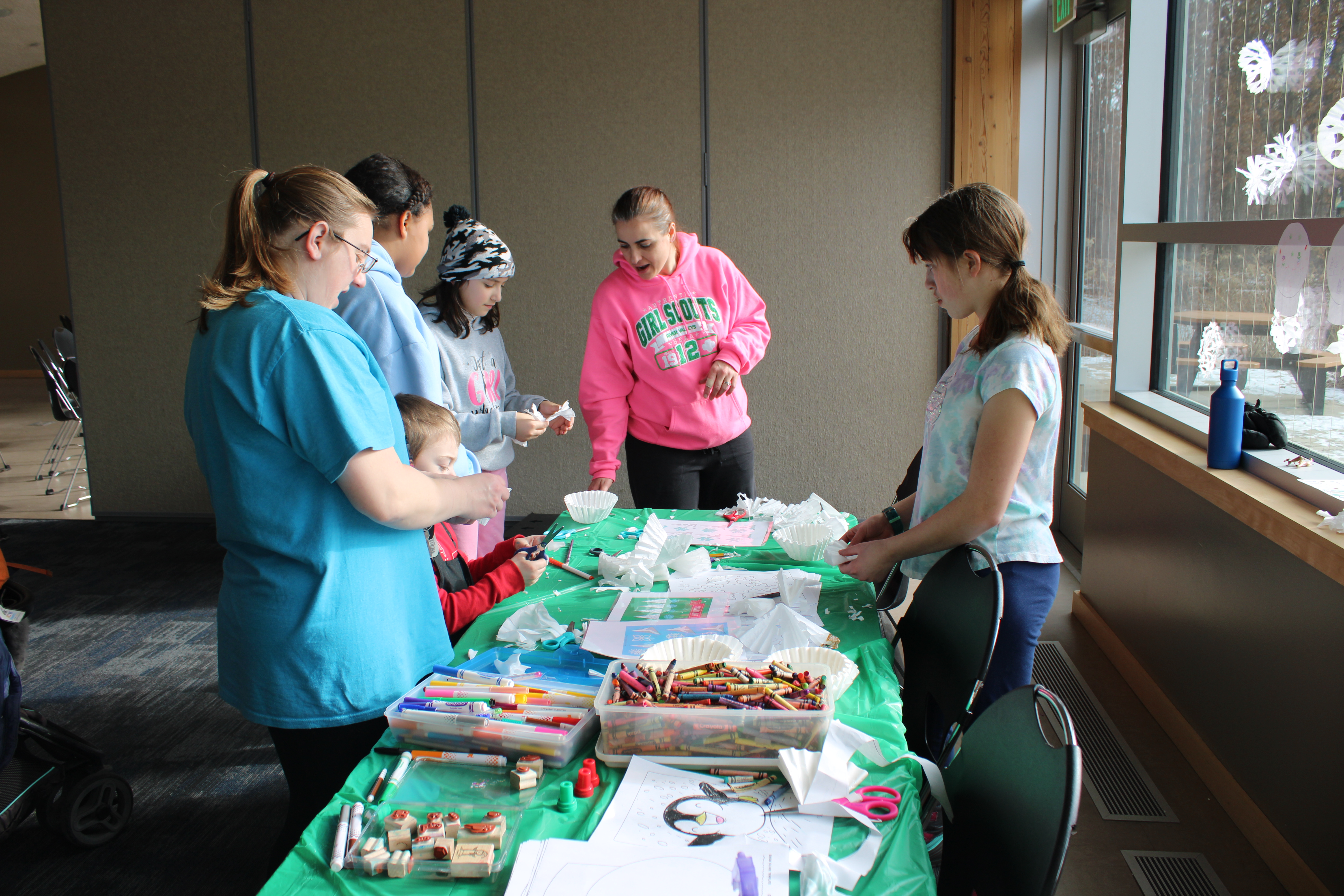people doing a craft in the community partner room 