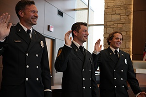 Three firefighters being sworn in at a promotional ceremony