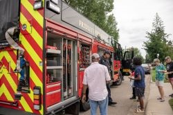 Residents looking at a fire truck at Night to Unite