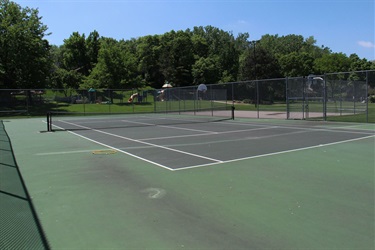 A tennis court in a park