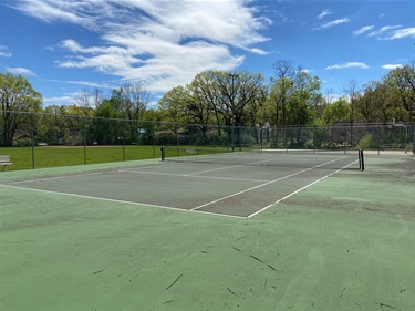 A single tennis court in a park
