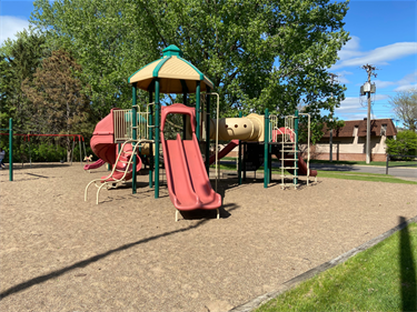 A playground with slides and climbing bars