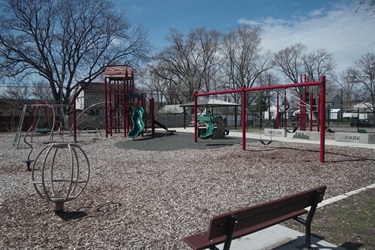 A bench looking out at a playground