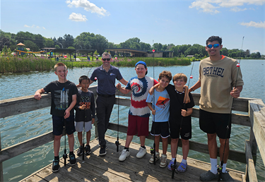 Staff at fishing program with kids