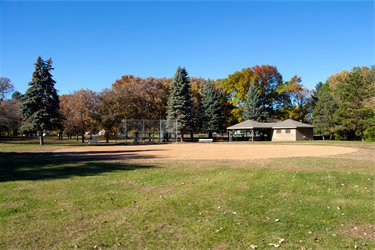 A ballfield next to a park building